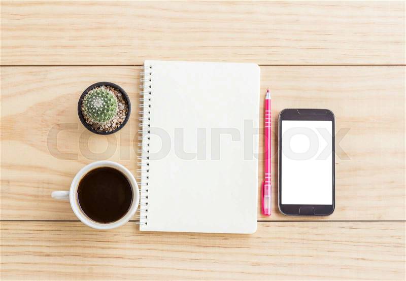 Vintage office desk table with notebooks,smart phone, pen and a cactus with cup of coffee. Top view with copy space. Business concept, stock photo