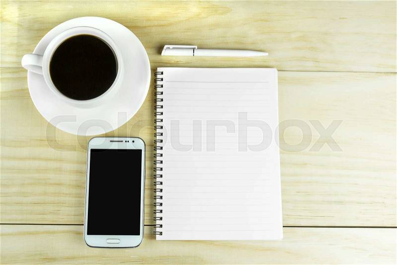 Smart phone, coffee and book blank with pen on wood table background. top view, stock photo