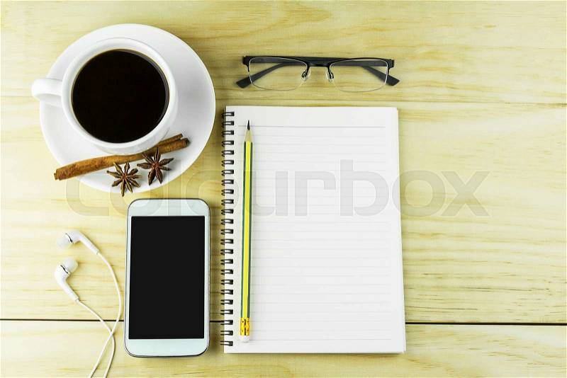 Smart phone, coffee,glasses and book blank with pencil on wood table background. top view, stock photo