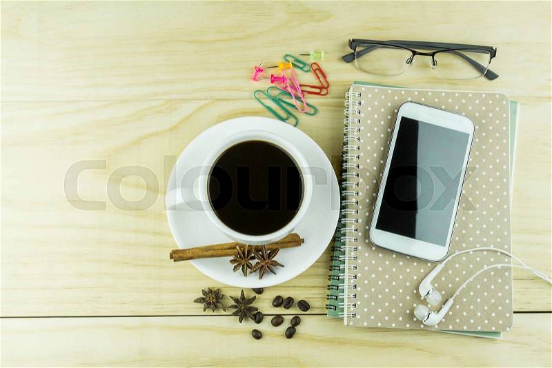 Smart phone, coffee,glasses and note book on wood table background. Business concept , stock photo