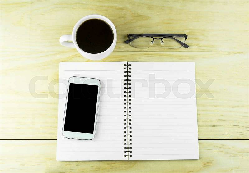 Smart phone, coffee,glasses and book blank on wood table background. top view, stock photo