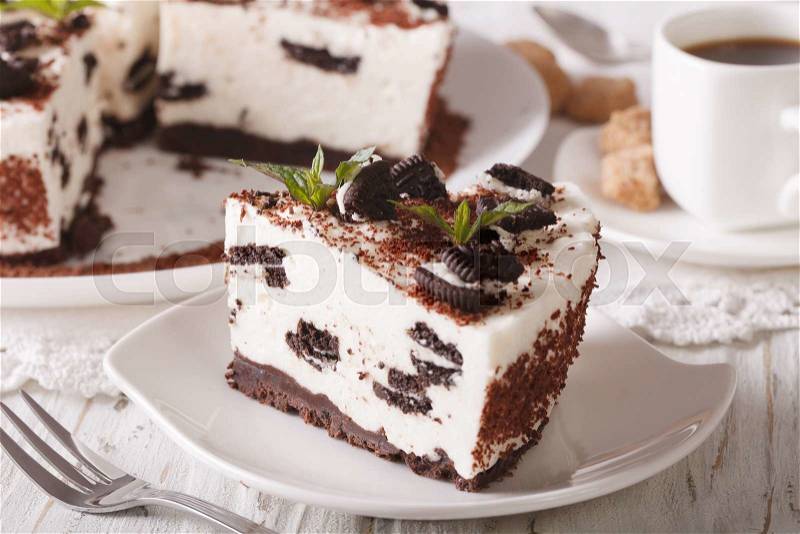 Cheesecake with pieces of chocolate cookies close-up and coffee. horizontal , stock photo