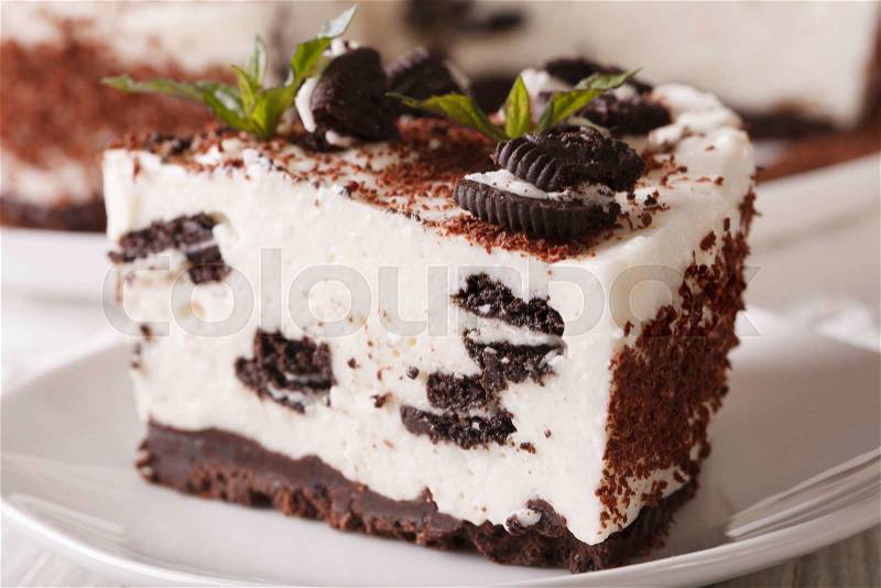 Cheesecake with pieces of chocolate cookies on a plate macro. horizontal , stock photo