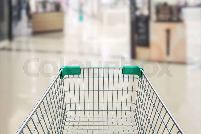 Rear view of empty shopping cart with shopping mall or grocery background, stock photo