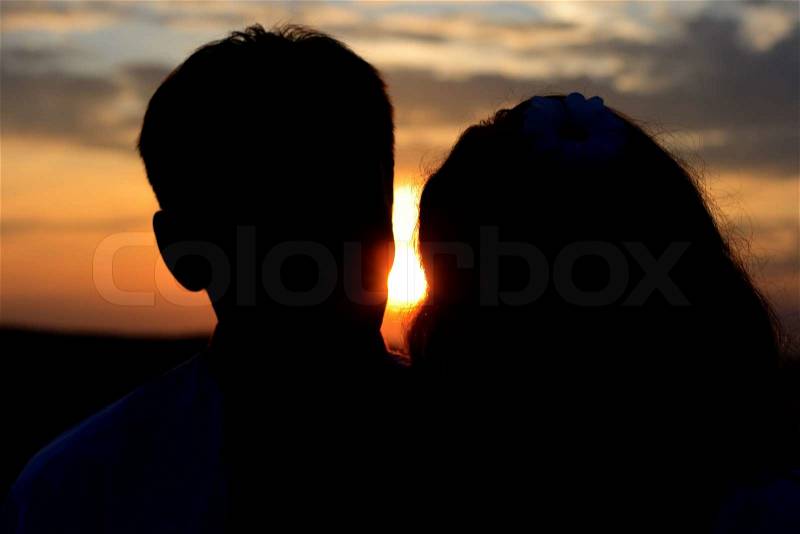 A wonderful sunset and a warm loving hug. What could possibly be better, stock photo