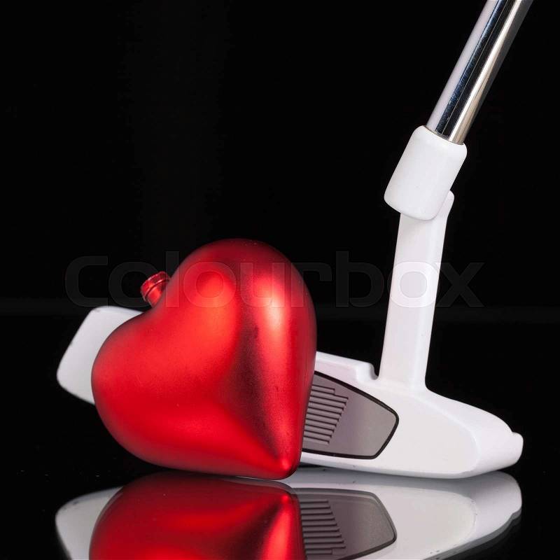 Golf putter and love symbol on the black glass desk, stock photo
