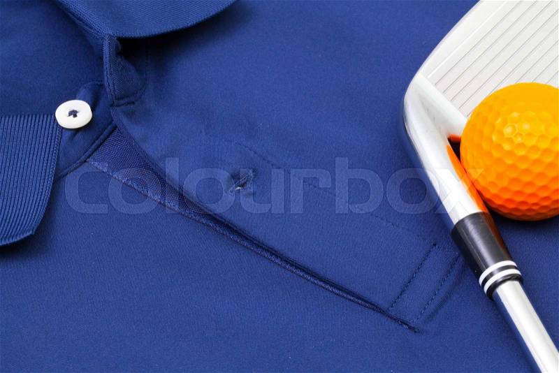 Detail of blue polo shirt and golf equipments, stock photo