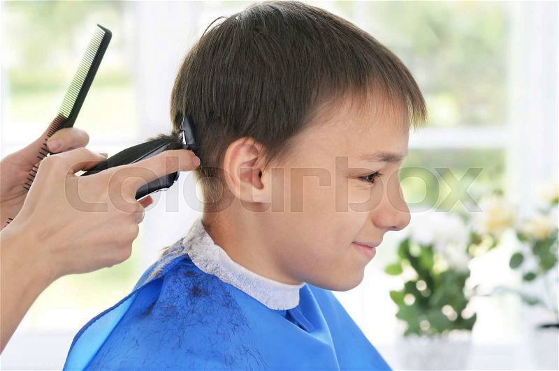 Portrait of happy client getting haircut from female hairdresser at salon, stock photo