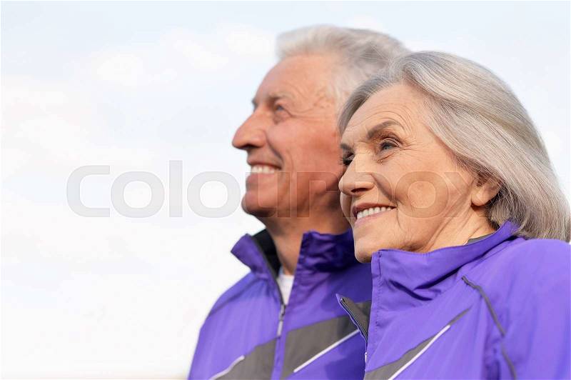 Happy fit senior couple exercising in park, stock photo