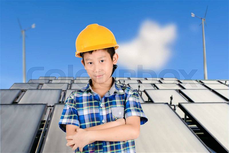 Asian boy with Group of Solar panel system ,turbine and sunny blue sky background, stock photo