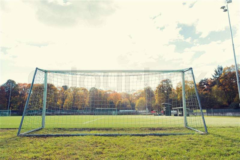 Sport and equipment concept - football goal on field, stock photo