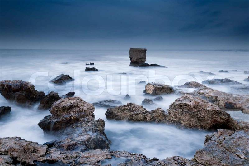 Bad weather night, sticking the stones from the raging sea, stock photo