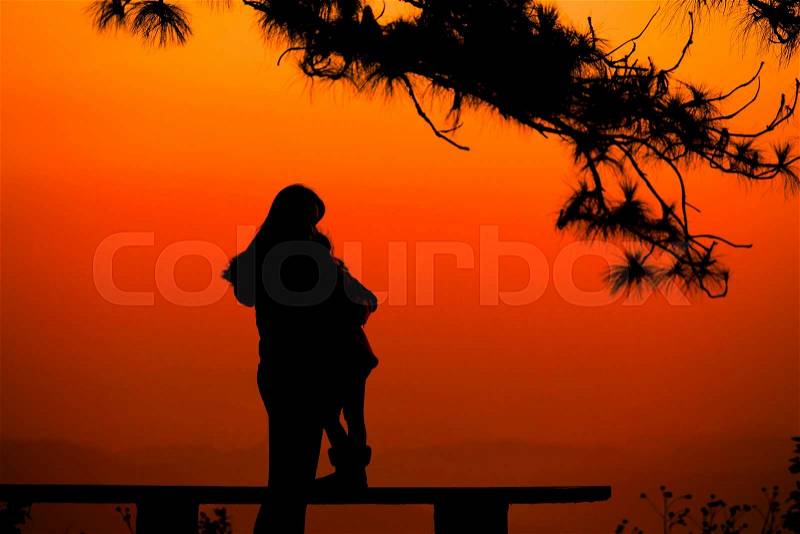 Silhouette mother and Child lovers natural background at the beach and mountain:black shadow loving people hug and kiss:love and valentines, stock photo