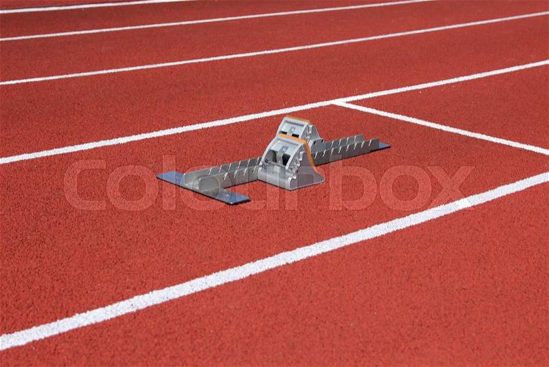 Athletics starting blocks on race track, stock photo