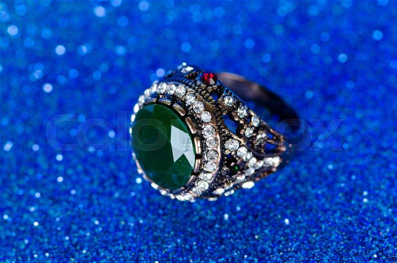 Jewellery ring against blue background, stock photo