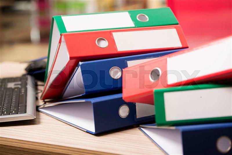 Stacks of office binders on desk, stock photo