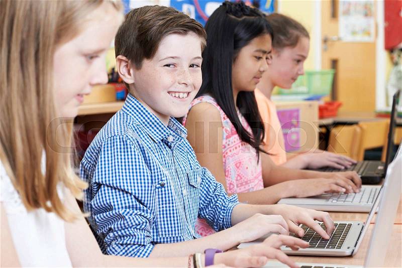 Group Of Elementary School Children In Computer Class, stock photo