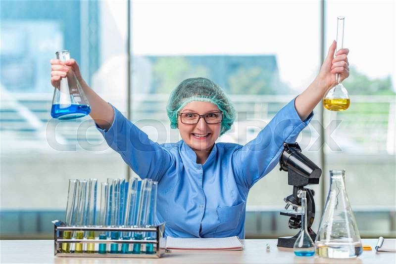 Experienced lab assistant working on chemical solutions, stock photo