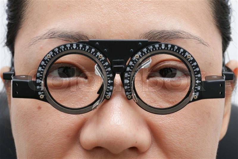 Asian Woman Doing Eyes Examination at Optics Store, stock photo