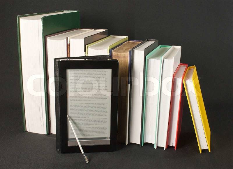 Row of printed books with electronic book reader on black background, stock photo