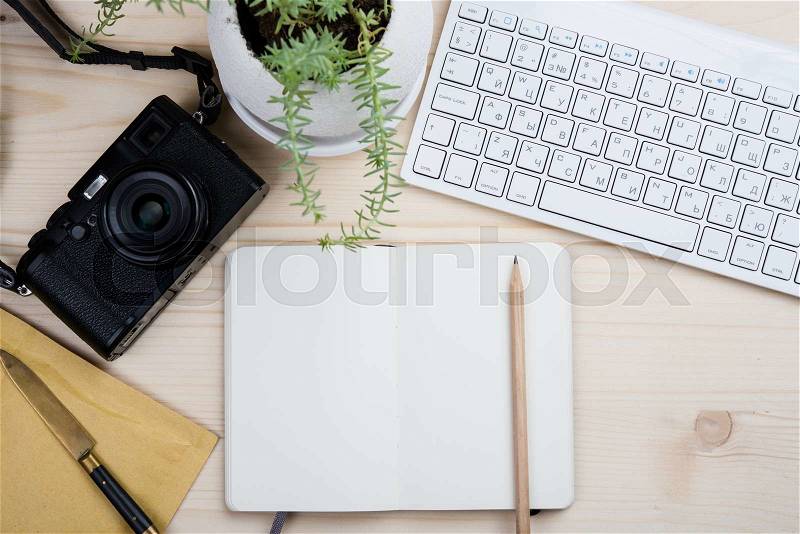 Photographers bloggers workplace tabletop, styled hipster\'s workspace, white computer keyboard and film camera, office desk top view with copy space, stock photo