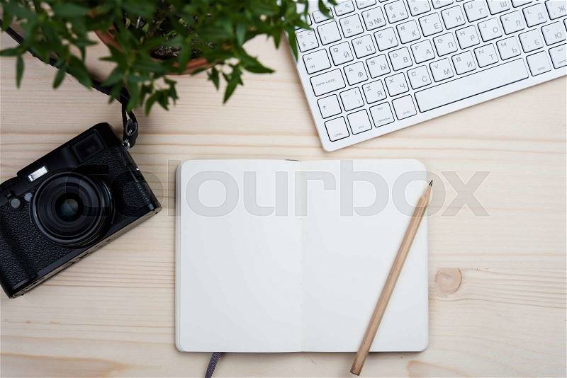 Photographers bloggers workplace tabletop, styled hipster\'s workspace, white computer keyboard and film camera, office desk top view with copy space, stock photo