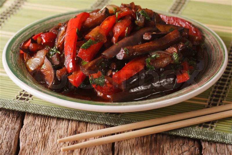 Eggplant Stir-Fry from Asian-style close-up on a plate on the table. horizontal , stock photo