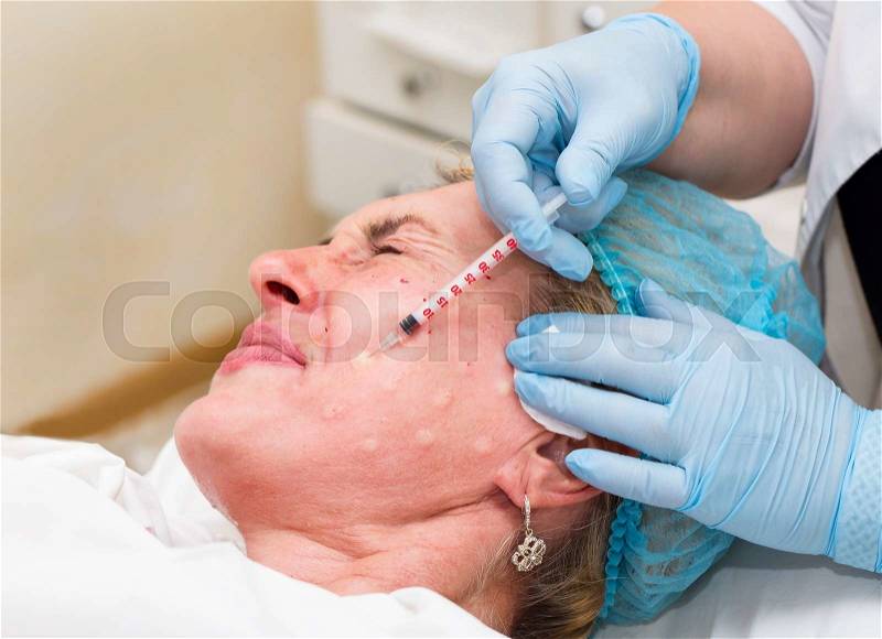 Cosmetic treatment with injection in a clinic, stock photo