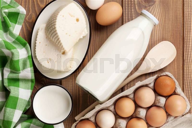 Dairy products on wooden table. Milk, cheese and eggs. Top view, stock photo