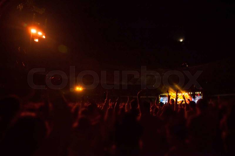 Silhouettes of people and musicians on big concert stage, stock photo