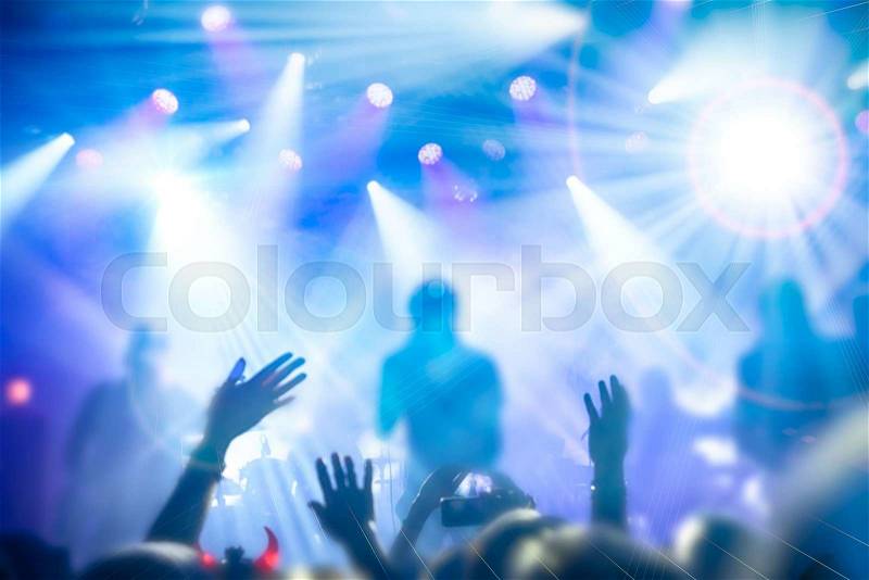 Silhouettes of people and musicians in big concert stage, stock photo