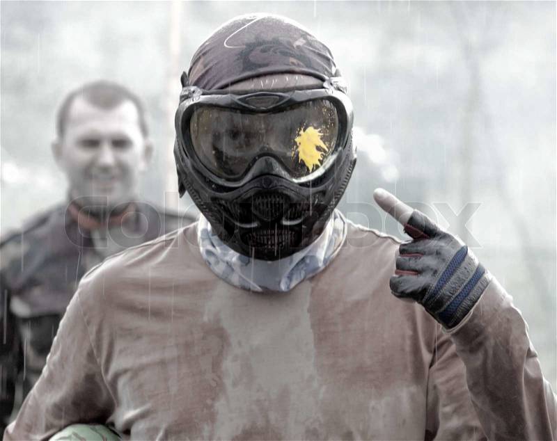 Athlete after a game of paintball in the rain, stock photo