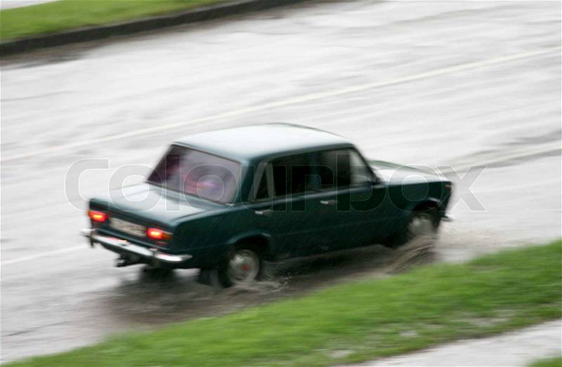 Car driving in rain, stock photo