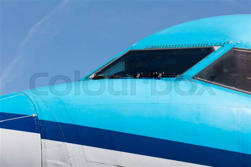 Cockpit close up of blue jet airplane, stock photo