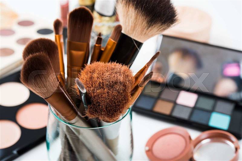 Professional makeup brushes and tools, natural make-up products set on white table, stock photo