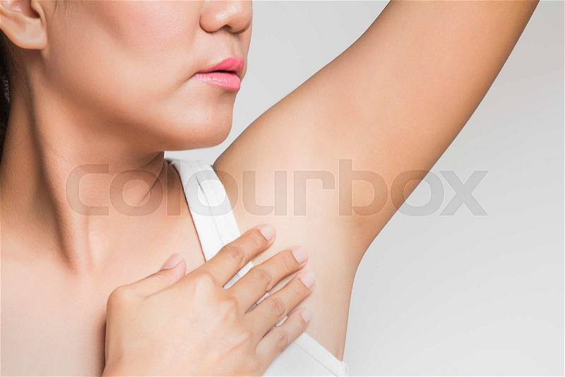 Woman holding her arms up and showing underarms, stock photo