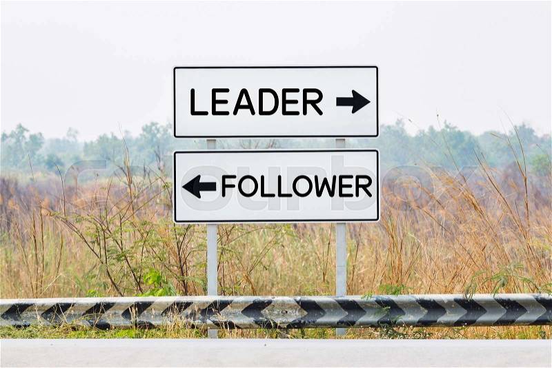 Road sign boards with leader and follower text, opposite wording concept, stock photo