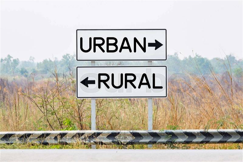 Road sign boards with urban and rural text, opposite wording concept, stock photo