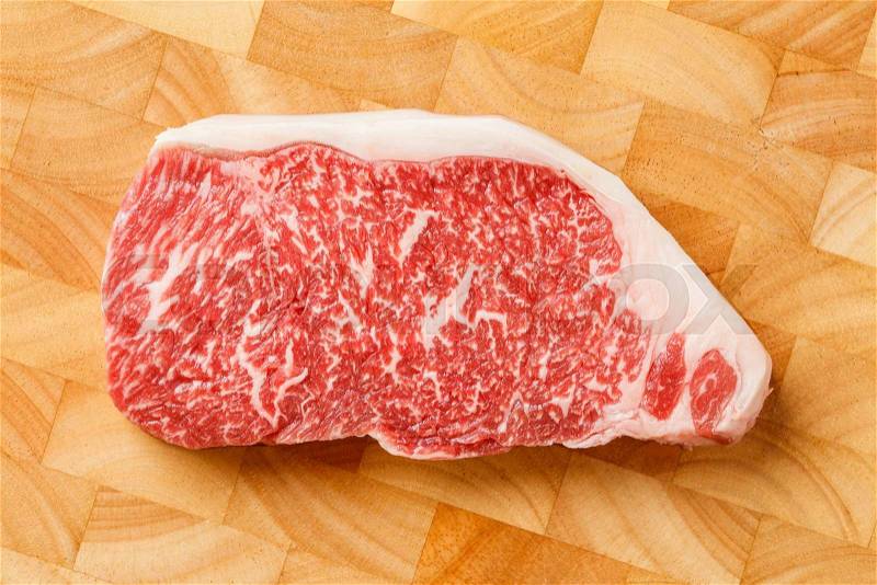 Close up wagyu beef striploin steak on cutting board, stock photo