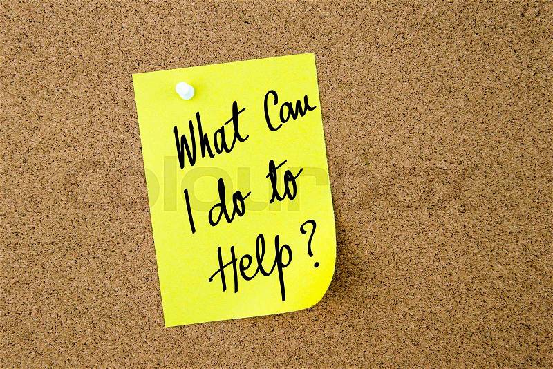 What Can I Do To Help ? written on yellow paper note pinned on cork board with white thumbtacks, copy space available, stock photo