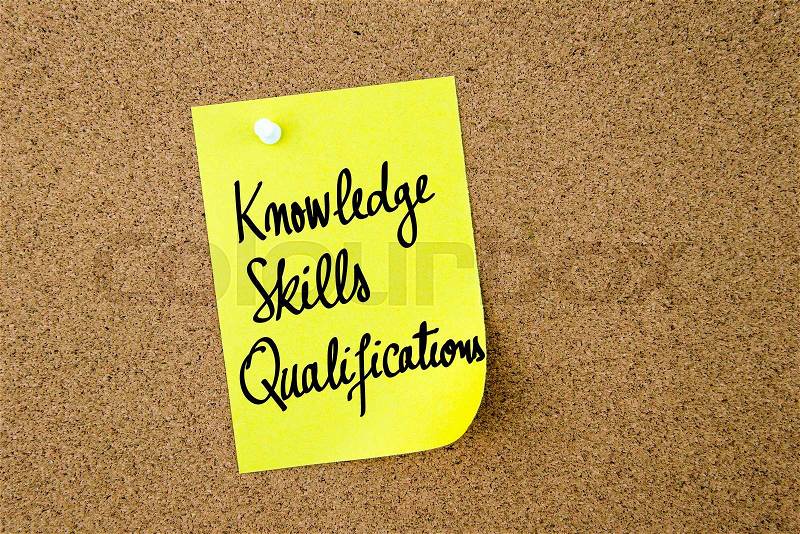Knowledge Skills Qualifications written on yellow paper note pinned on cork board with white thumbtacks, copy space available, stock photo