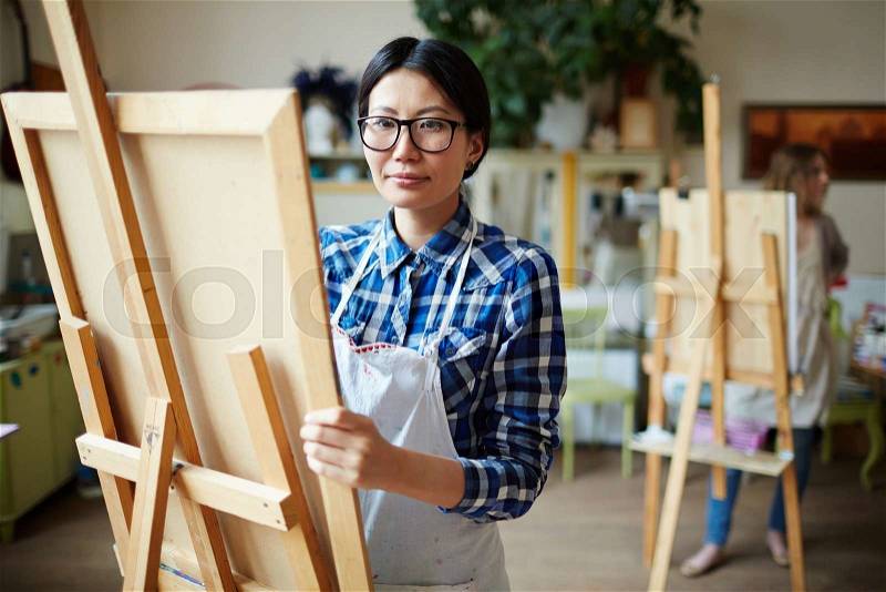 Young female studying in school of arts, stock photo