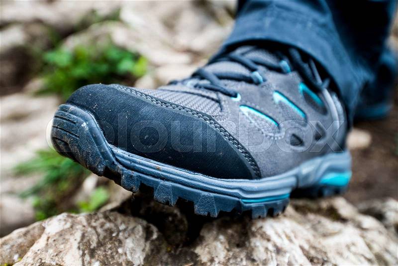 Hiking shoe on a rock, stock photo