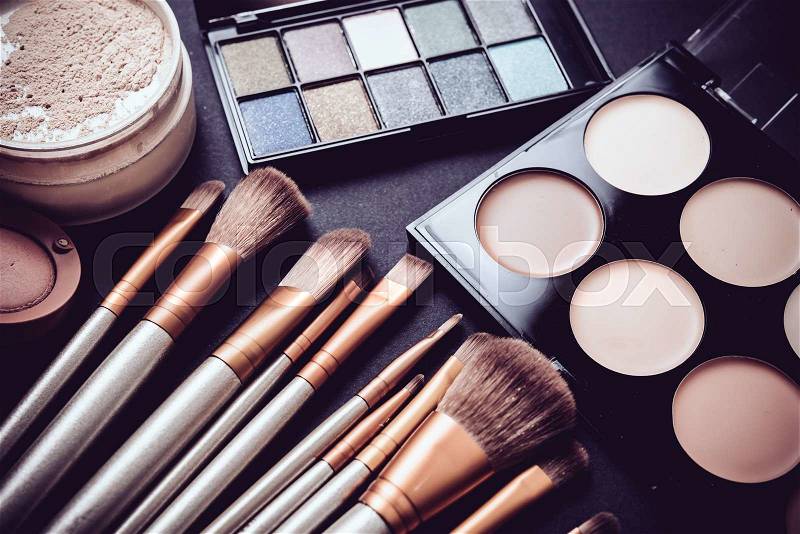 Professional makeup brushes and tools collection, make-up products set on black table background, stock photo