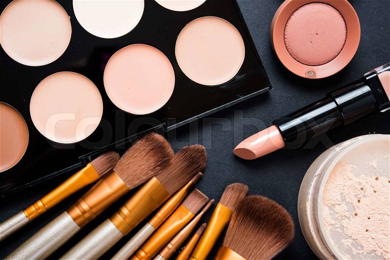 Professional makeup brushes and tools collection, make-up products set on black table background, stock photo