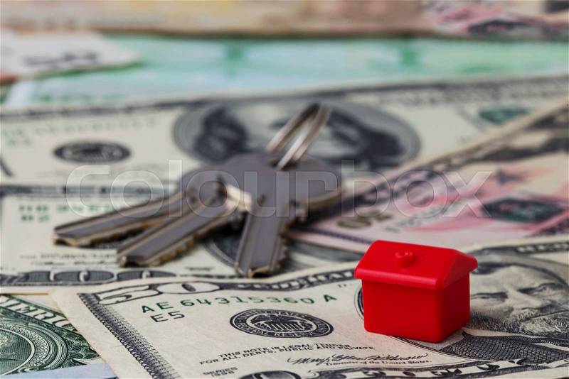 The red toy house on a money background, stock photo
