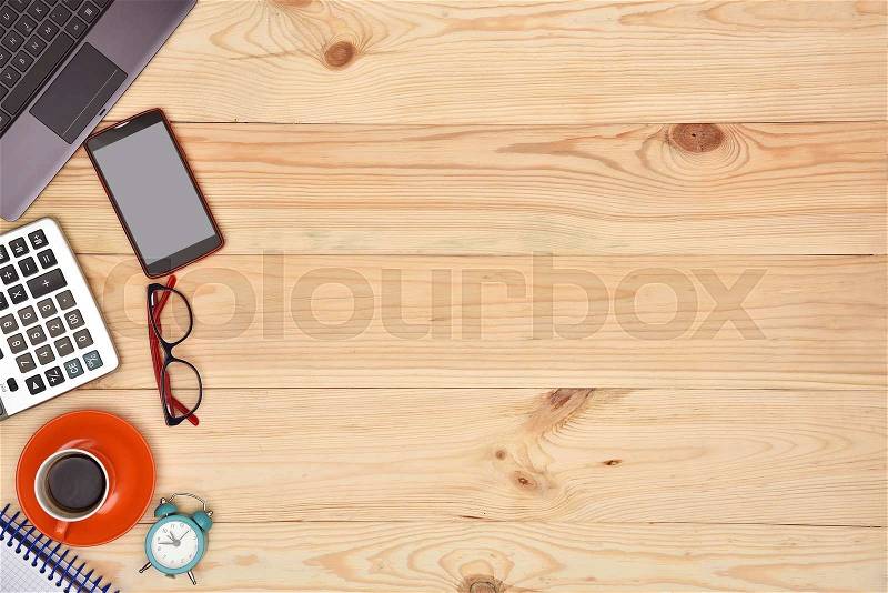 Laptop and material office desktop on wooden desk, top view, stock photo