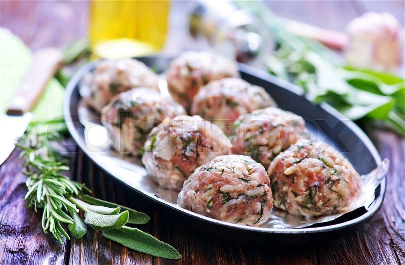 Raw meat balls on the foil and on plate, stock photo