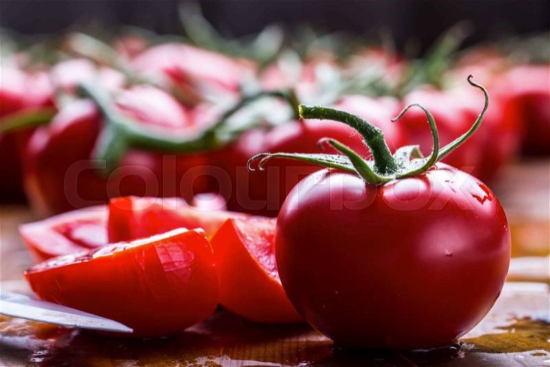 Fresh cherry tomatoes washed clean water. Cut fresh tomatoes, stock photo