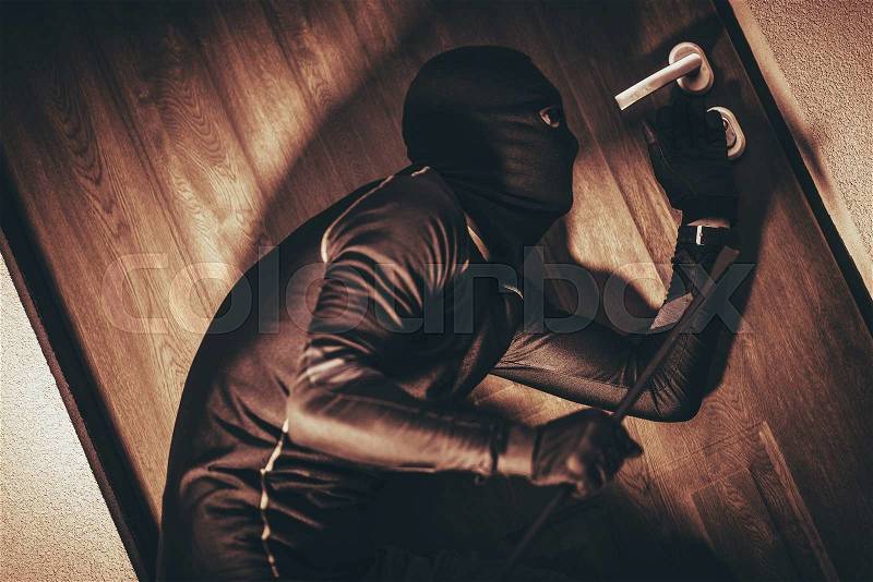 House Security Concept with Home Burglar in Action Trying To Break Into the House. , stock photo